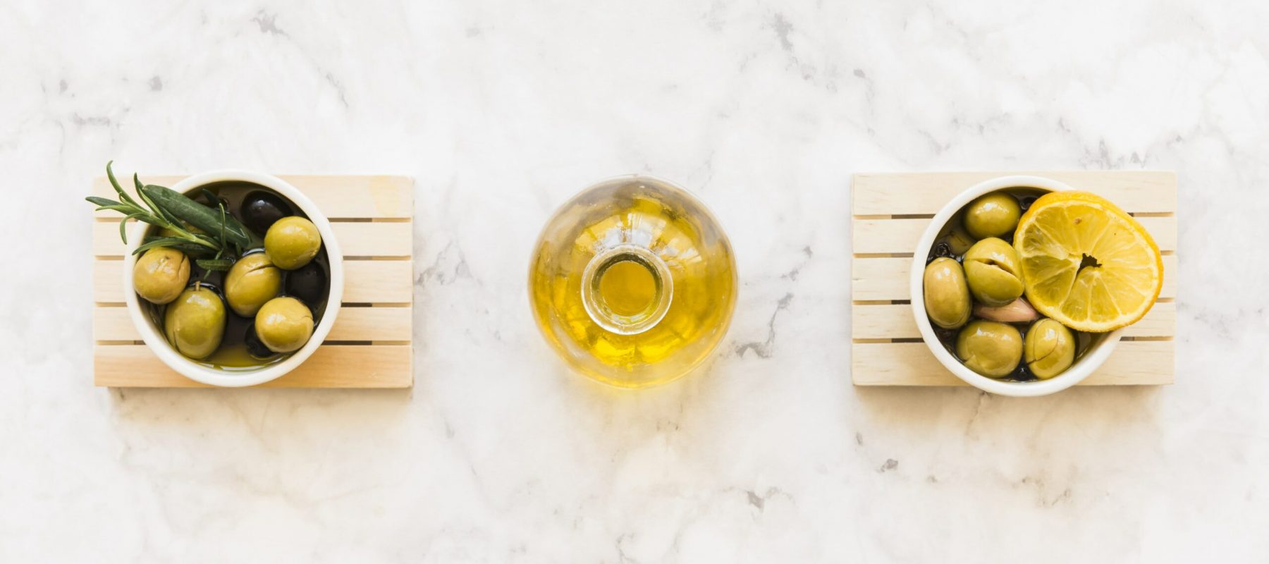 oil-bottle-two-bowls-olive-with-rosemary-lemon-slice-min